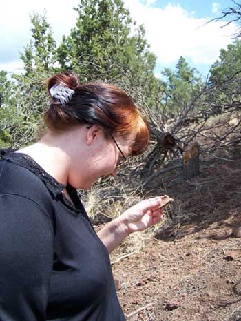 Amber examines a potsherd.