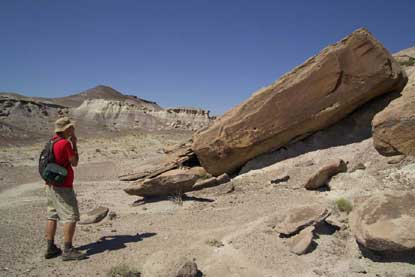 Brock stands next to large sandstone slab.