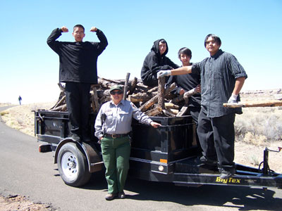 Students and NPS employee show off one of several truckloads of timbers removed from trail.