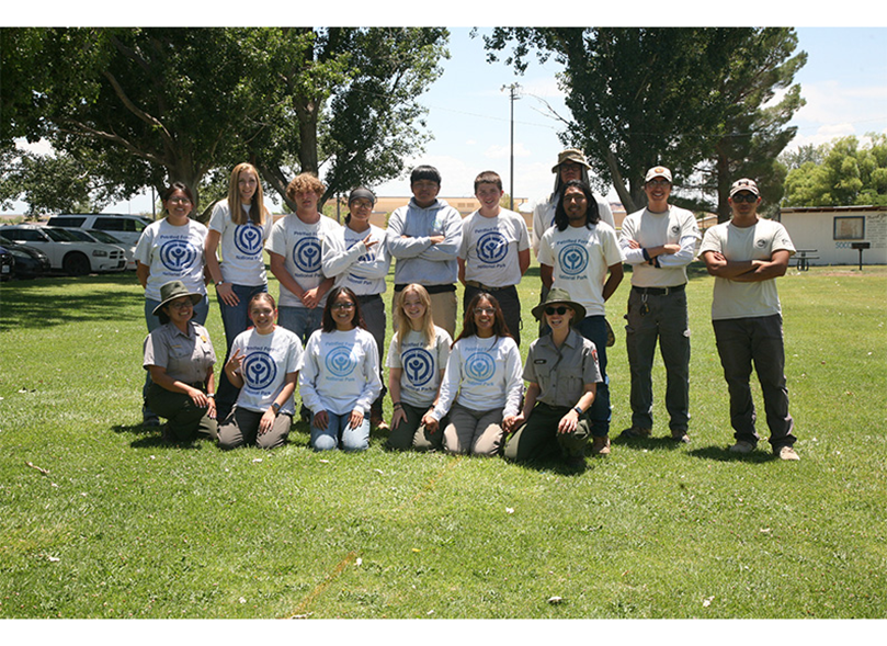 YCC Members 2024 YCC Members 2024, group of people standing in a green park with grass and trees.