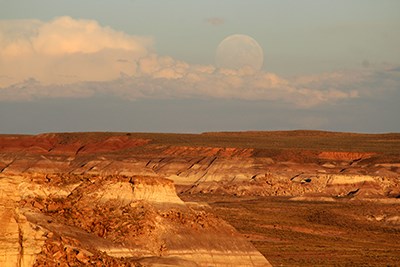 Full moon rising over sunset lit Blue Mesa