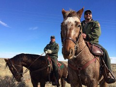 Two park staff members on horseback