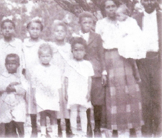 Black and white image of an African American family - parents and eight children