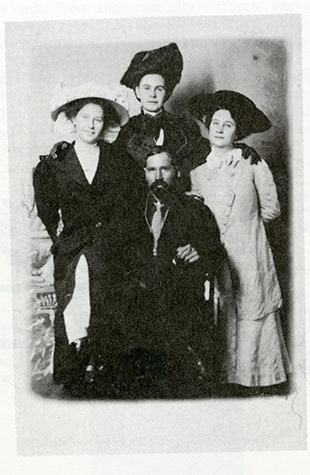 JOTR_Keys A fading black and white photo of (from left to right) Muriel, Hortense, and Frances Lawton with Bill Keys in the middle.