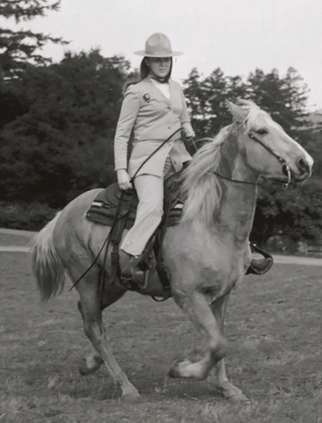 Lynn Strong in uniform riding a horse
