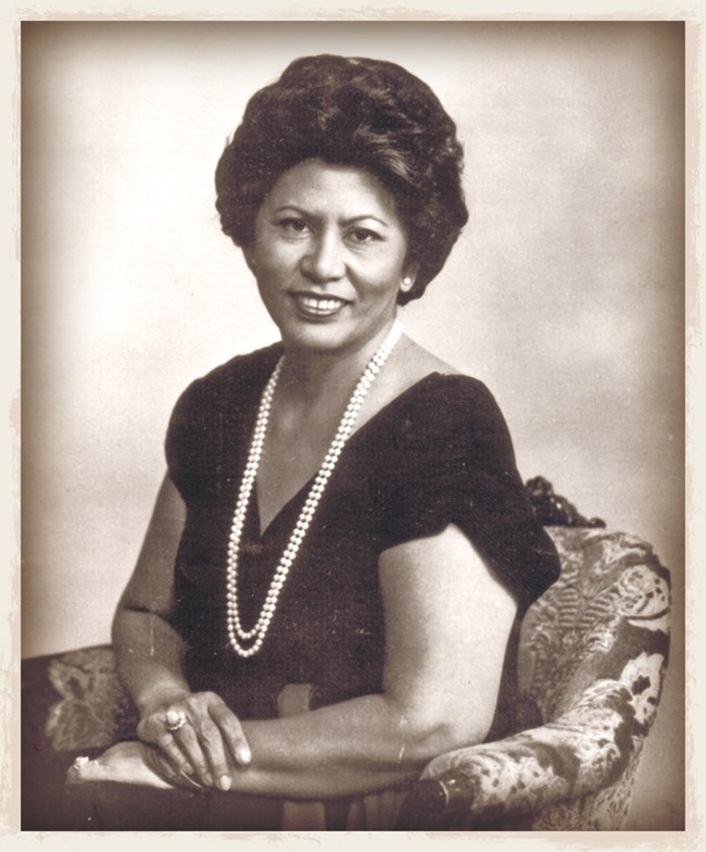 WAPA_Bamba An old photo of Cecilia Cruz Bamba sitting down in a chair and smiling for the camera.