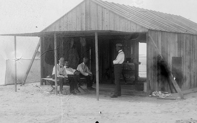 Men sitting and standing in a building