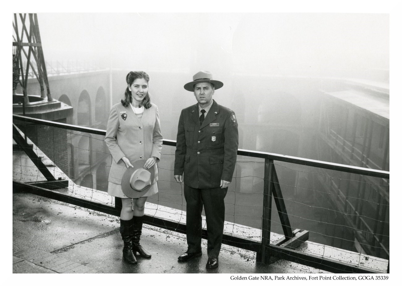 Charlie Hawkins & female NPS employee. Two rangers stand on the third floor of Fort Point.