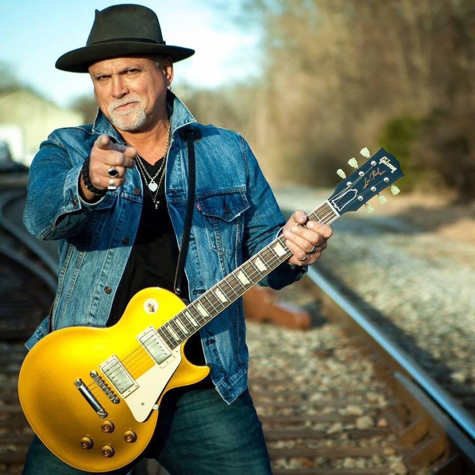 a picture of derek St. Holmes holding a Les Paul a picture of derek St. Holmes holding a Les Paul