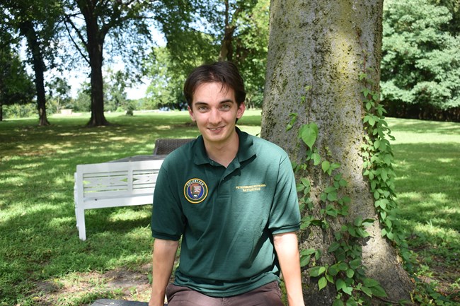 A white male wearing a green NPS volunteer polo shirt