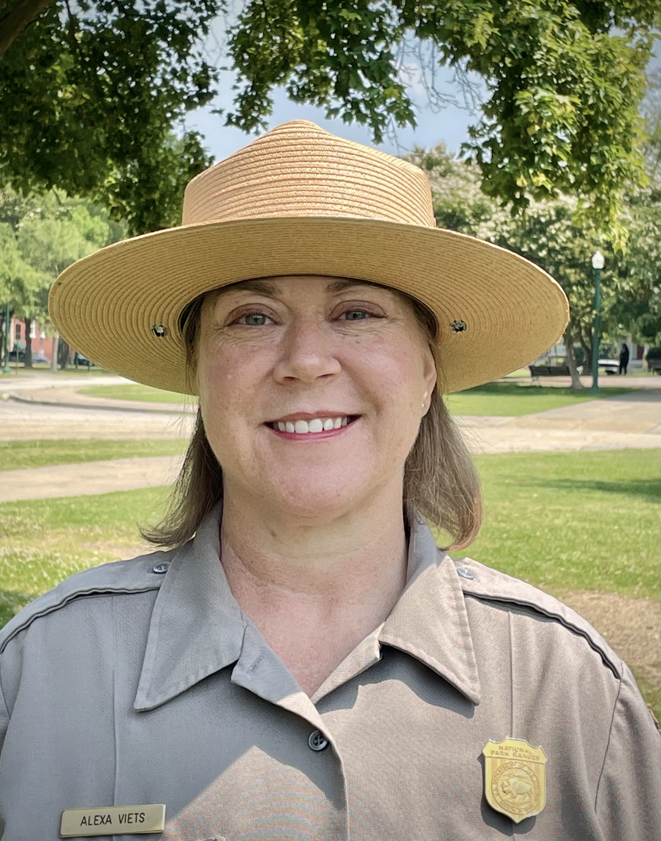 A woman smiles into the camera