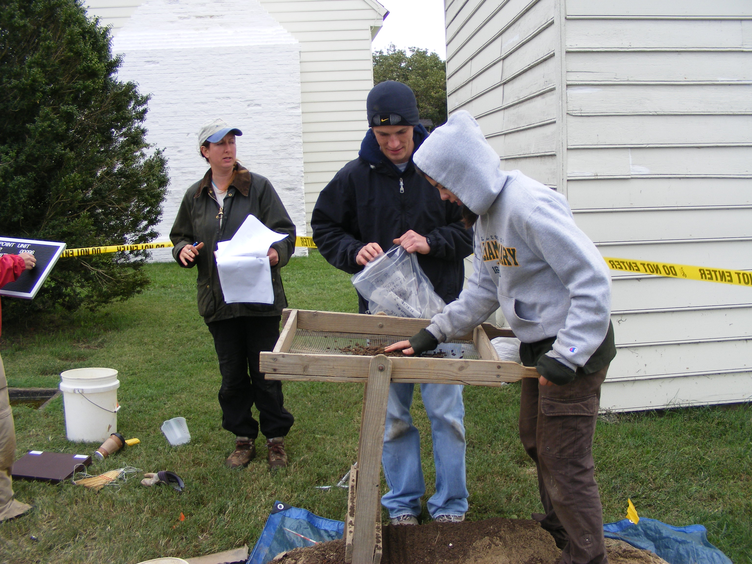 City Point Archeology Two white students; one male, one female using a screen to sift dirt through a strainer as they search for artifacts at Appomattox Plantation.