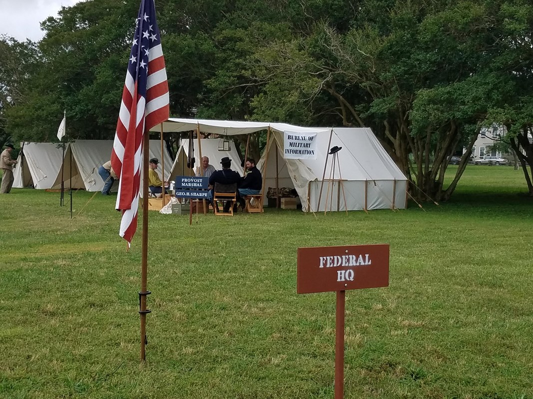 living history at City Point2 A white canvas tent next to trees with a sign that says Federal HQ. In front is the U.S. Flag on a pole.