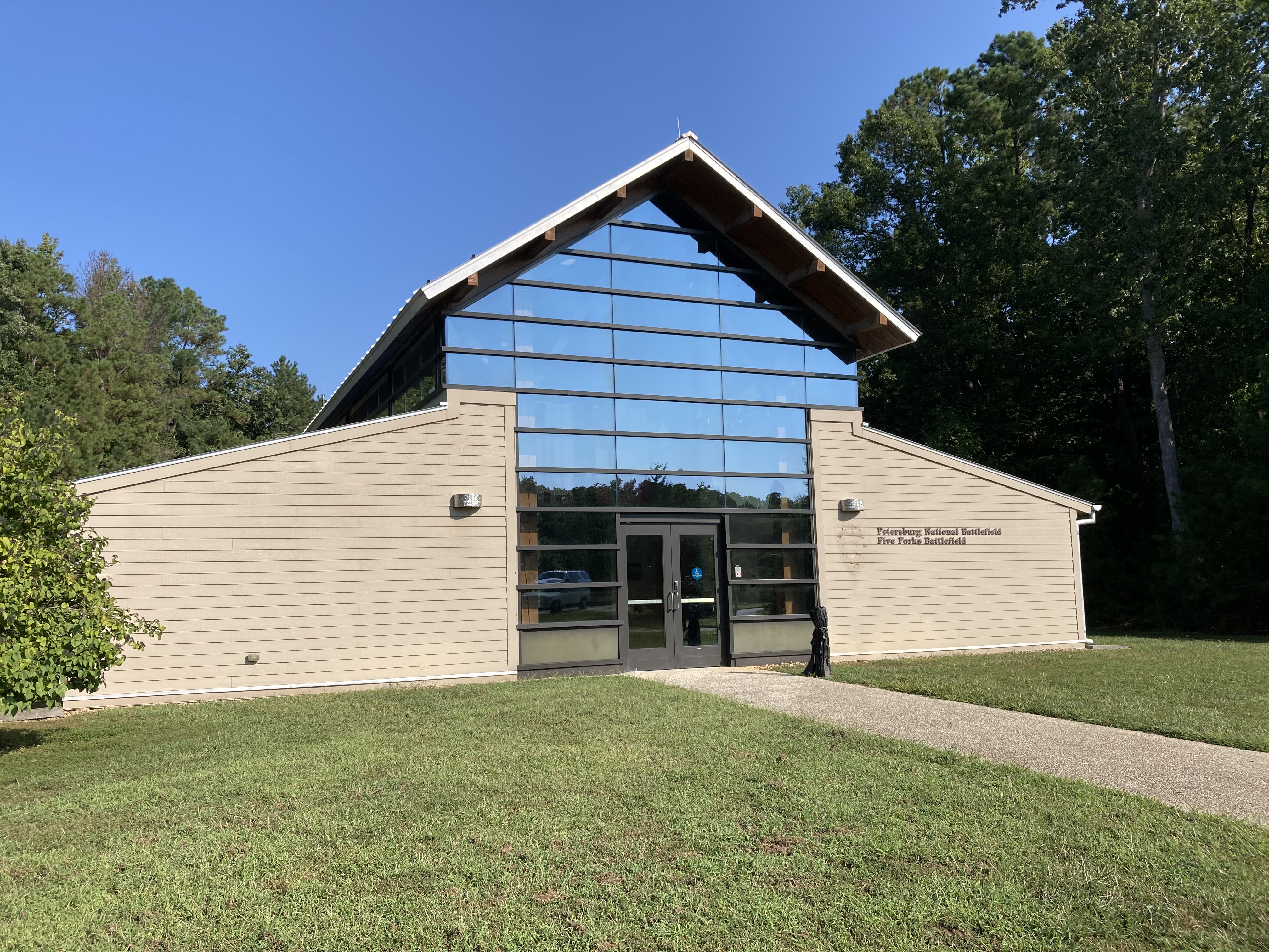 Barn shaped building with the center of the end wall being a roof to ground window.