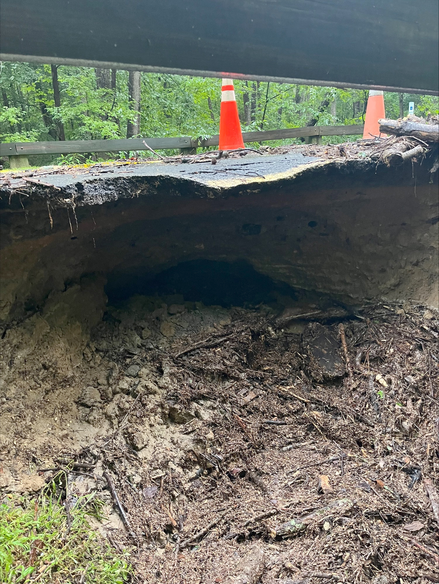 Erosion craved out a section under a road approximately 3 feet deep.