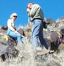 Two Volunteers photographing petroglyphs