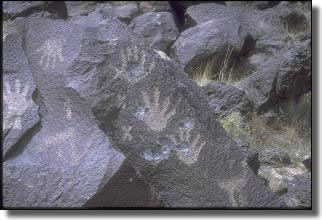 Images of hands etched on rocks