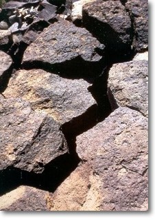 Photograph of fractured columnar basalt.
