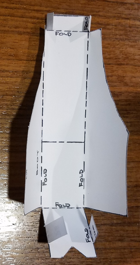 A cut out piece of paper has 7 fold put in it along dotted lines.