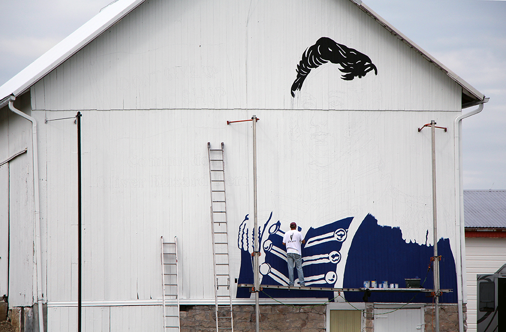 Barn artist Scott Hagan paints an image of Oliver Hazard Perry on the side of the Schimming’s barn on SR 105 just west of Oak Harbor as part of the Ohio History Connection Barn project.