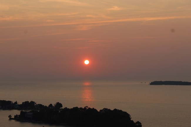 Sunset over open water with islands