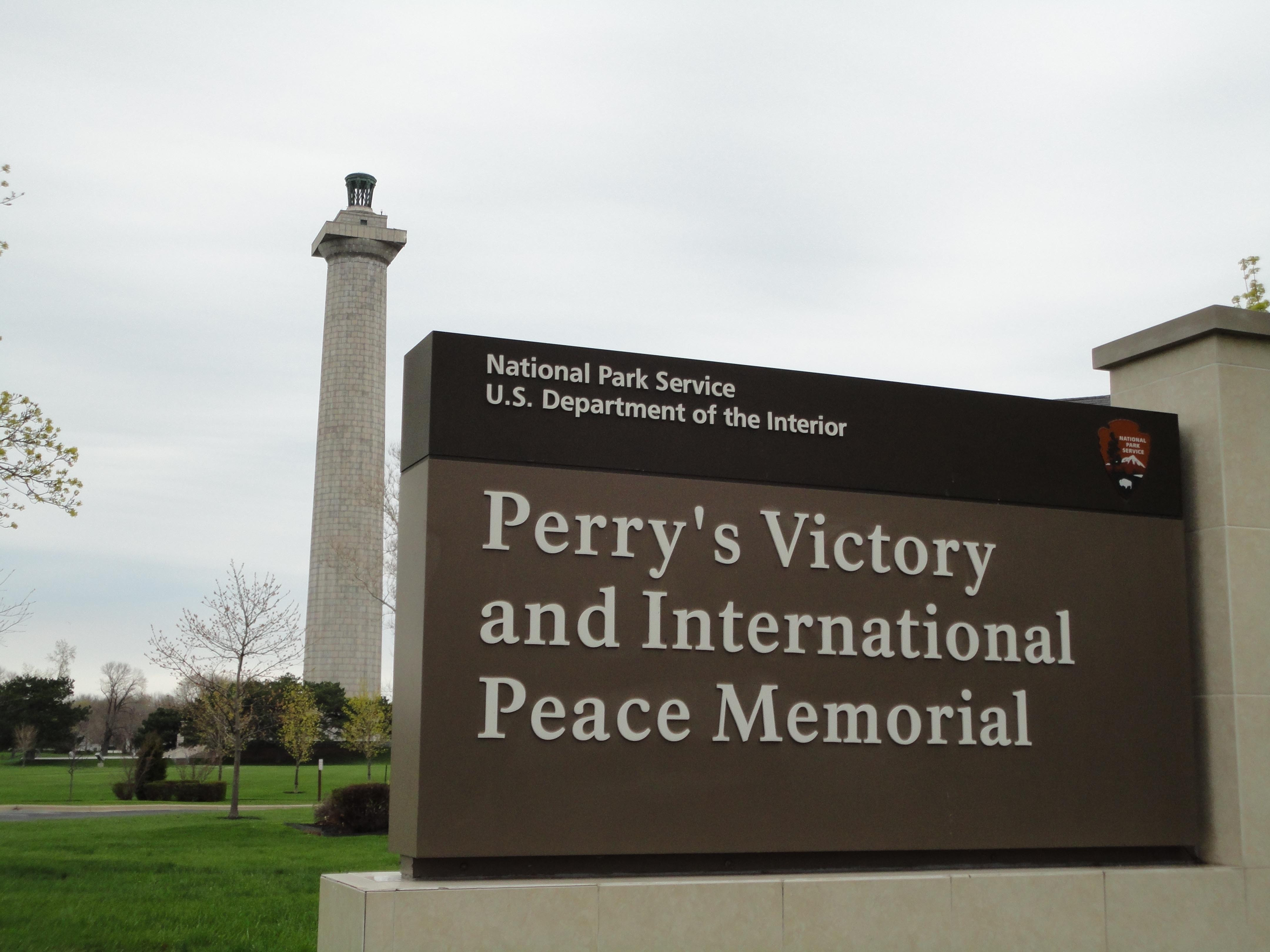 Perry's Victory and International Peace Memorial Sign with Memorial in background. Perry's Victory and International Peace Memorial Sign with Memorial in background.