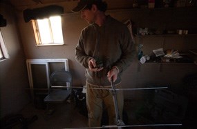 A biologist readies his tracking equipment in the observation blind on the morning of the release event.