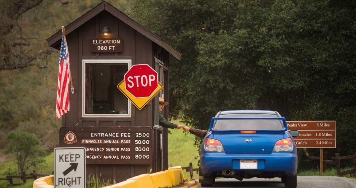 A car passes through the entrance station of Pinnacles. A car passes through the entrance station of Pinnacles.