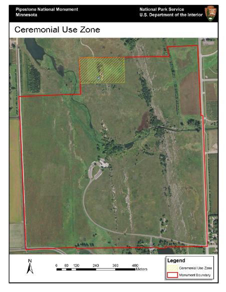A bird's eye view of the park, whose boundary is delineated by a red line. At the northern limit of the area is a polygon with diagonal yellow stripes denoting the ceremonial use zone.