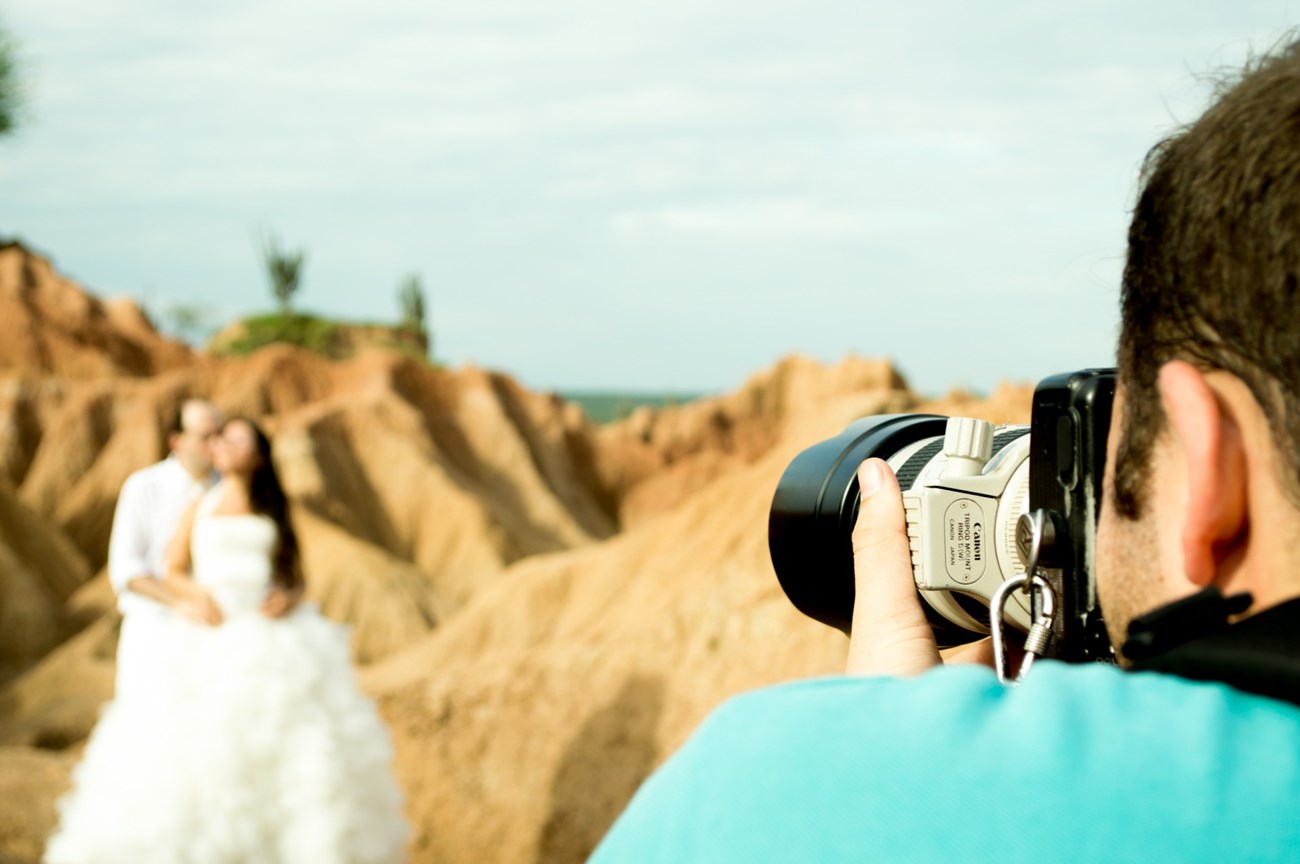 A phtographer taking a picture of a couple getting married