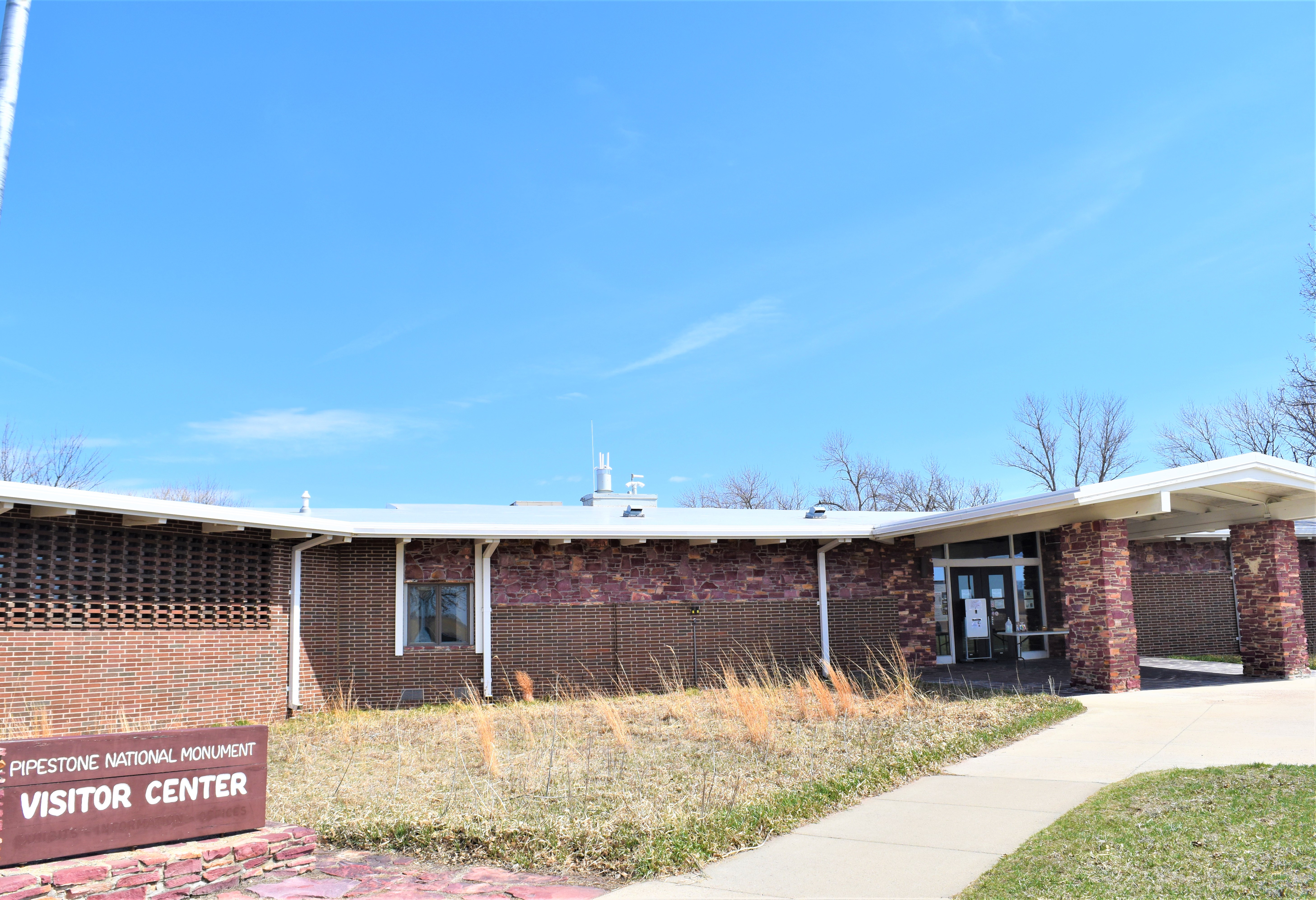 Exterior of a building next to a sign on a sunny day