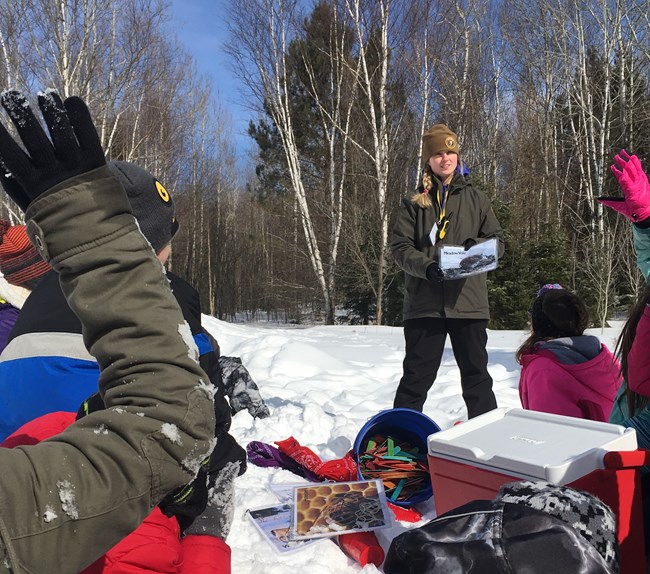 Intern and 4th graders outside on the snow