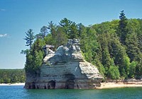 Miners Castle rises out of Lake Superior, and is the most well-known formation of the Pictured Rocks. Miners Castle rises out of Lake Superior, and is the most well-known formation of the Pictured Rocks.