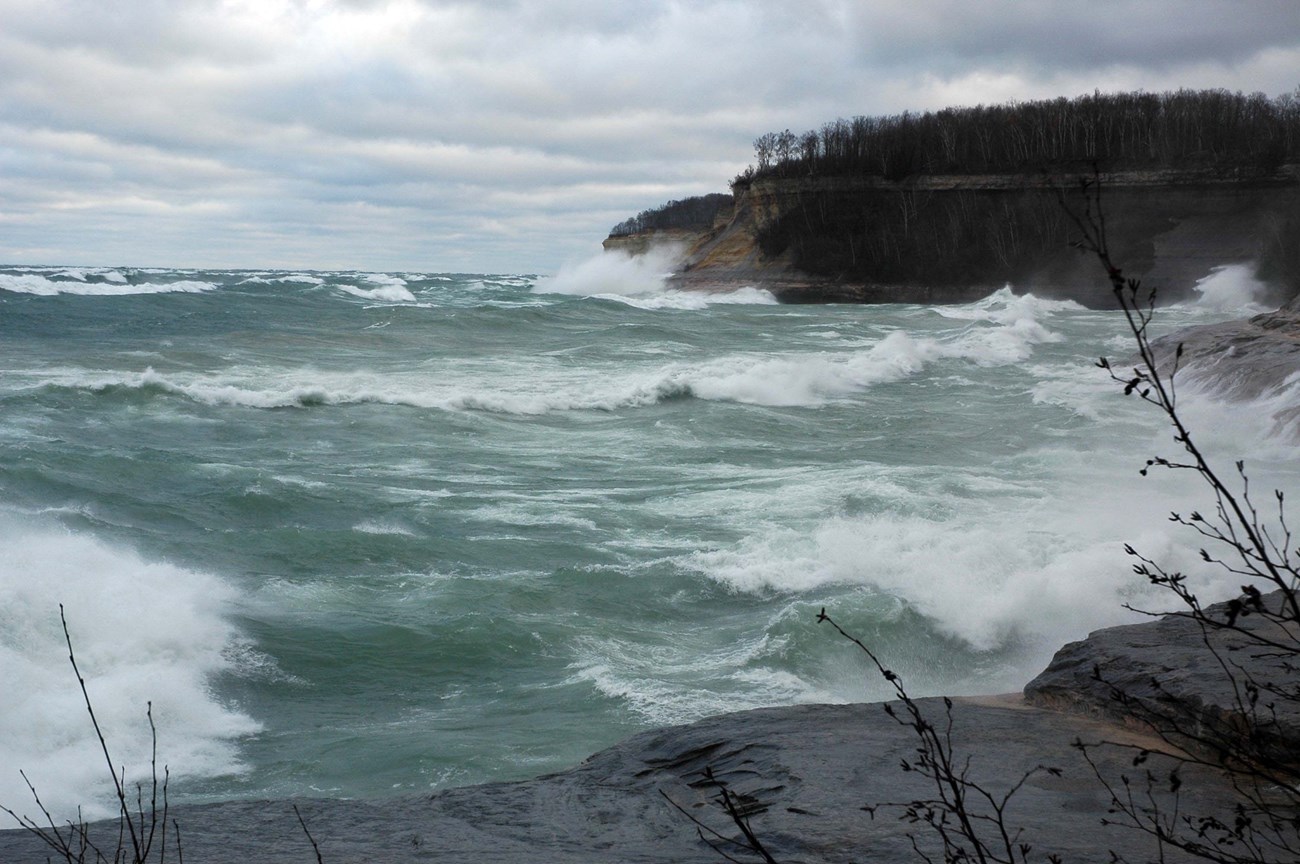 Large waves batter a rocky coastline in a violent storm