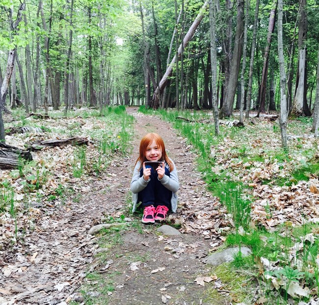 Young girl on forest trail
