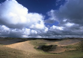 Brilliant white clouds and blue sky above a pristine area of the Grand Sable Dunes