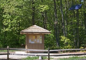 This quaint building houses solar equipment to power the water well. The solar panel is on a tall pole at the right corner.