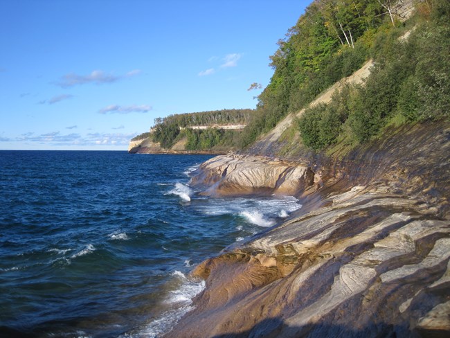 Waves crashing at cliff shoreline