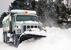 Lakeshore truck plows snow along Sand Point Road.