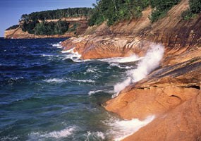 Lake Superior waves splash onto the Pictured Rocks cliffs. Lake Superior waves splash onto the Pictured Rocks cliffs.