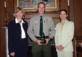 Chris Case received an Environmental Achievement Award, and is shown with Interior Secretary Gale Norton and Assistant Secretary Lynn Scarlett in the Secretary's official office.
