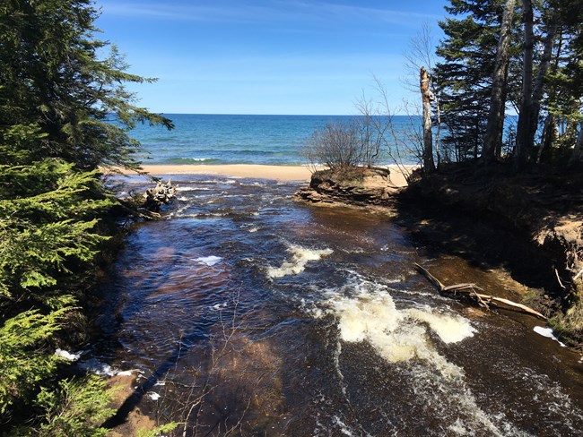 Mouth of Hurricane River flowing into Lake Superior, as seen from bridge