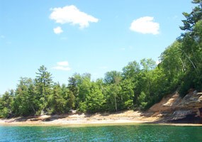 The Lake Superior shoreline near the mouth of the Mosquito River with beautiful blue skies and clear emerald water. The Lake Superior shoreline near the mouth of the Mosquito River with beautiful blue skies and clear emerald water.