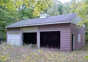 This three stall brown garage, located in the Beaver Basin, is shown as it is being taken down for later installation in Grand Marais.