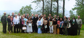 Newly naturalized citizens pose with Judge Greeley and Superintendent Northup near Miners Castle.
