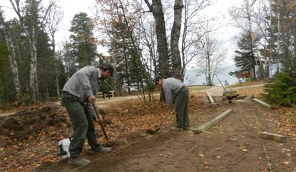 Maintenance workers place a walkway at Hurricane River.