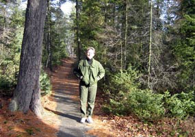 This park employee is hiking on the Sand Point Marsh trail, enjoying an unusual January without snow on the ground.