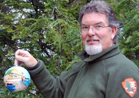 The 2007 White House tree ornament features oil paintings of three lakeshore scenic areas. With a hemlock tree as a background, it is held by its artist, PRNL Chief of Heritage Education Gregg Bruff