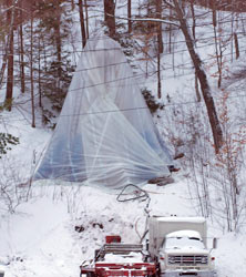 The Munising rear range light is covered in a plastic tent as sandblasting is underway.