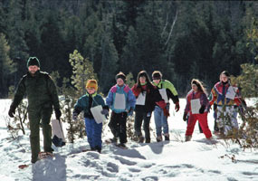 Junior Rangers explore the white winter landscape on snowshoes